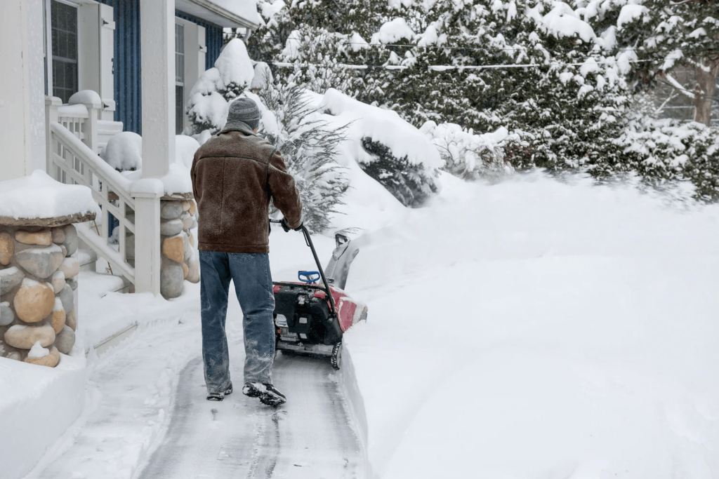 Man Removing Snow and Ice from the Environment